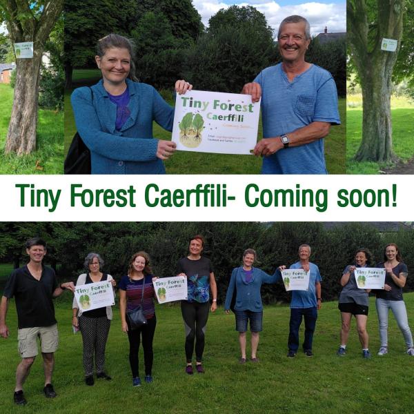 Tiny Forest Caerphilly team holding up posters to promote the project
