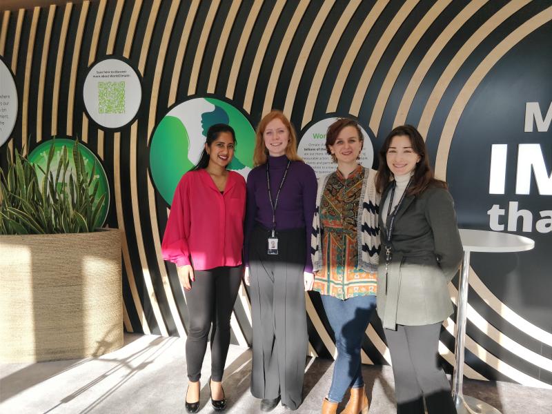 Anneke Deva standing beside 3 women participants at the first corporate Money Movers event at Deloitte offices.