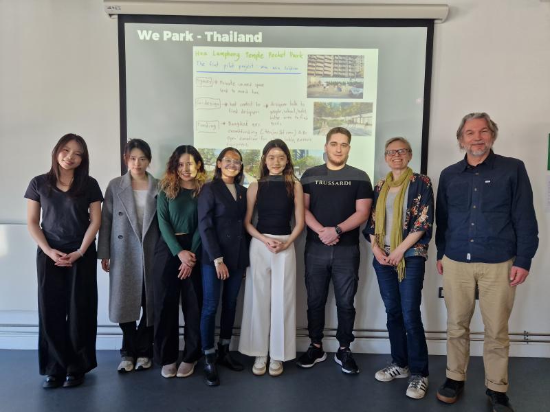 A group of Bristol MSc students with Mary Stevens and Terry Dixon, Head of Growth and Innovation at Sparck standing in front of screen