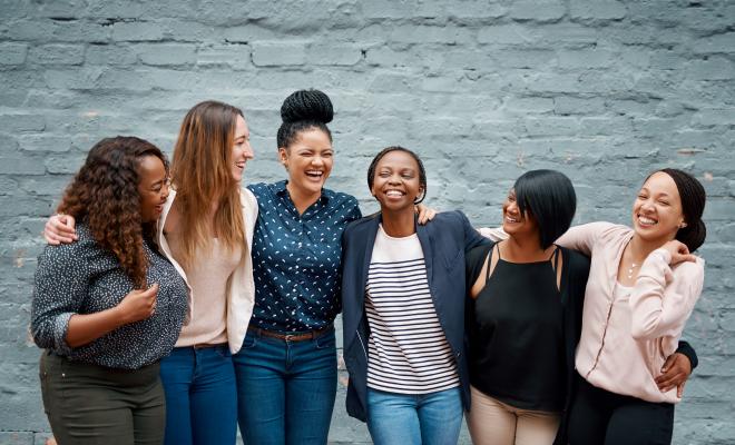 Women standing in a line, laughing
