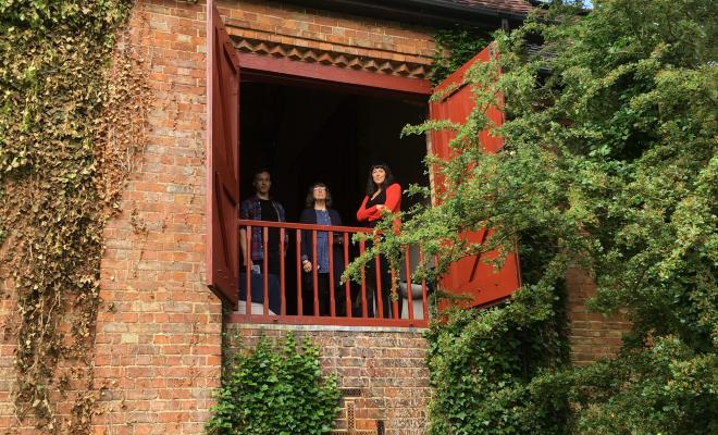 People looking out from balcony in Quadrangle Trust barn